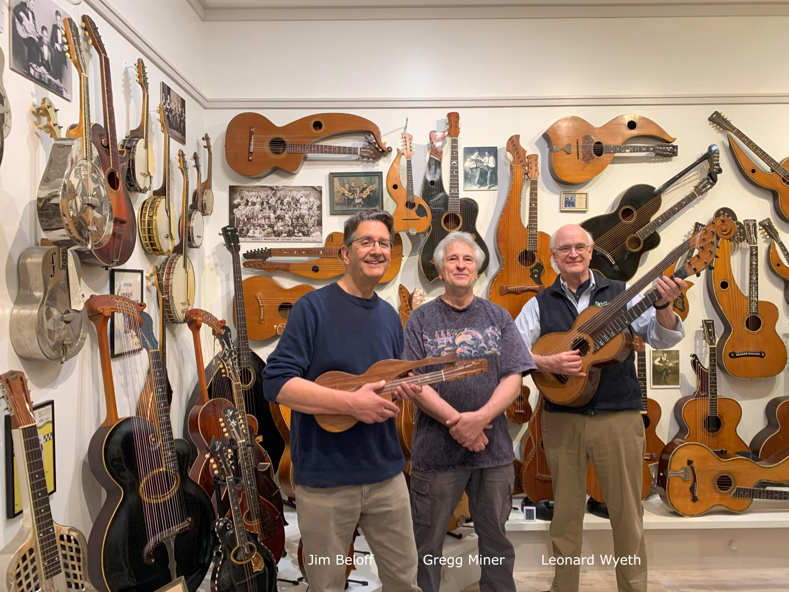 Leonard Wyeth and Jim Beloff standing inside Gregg Miner’s Miner Museum of harp guitars.