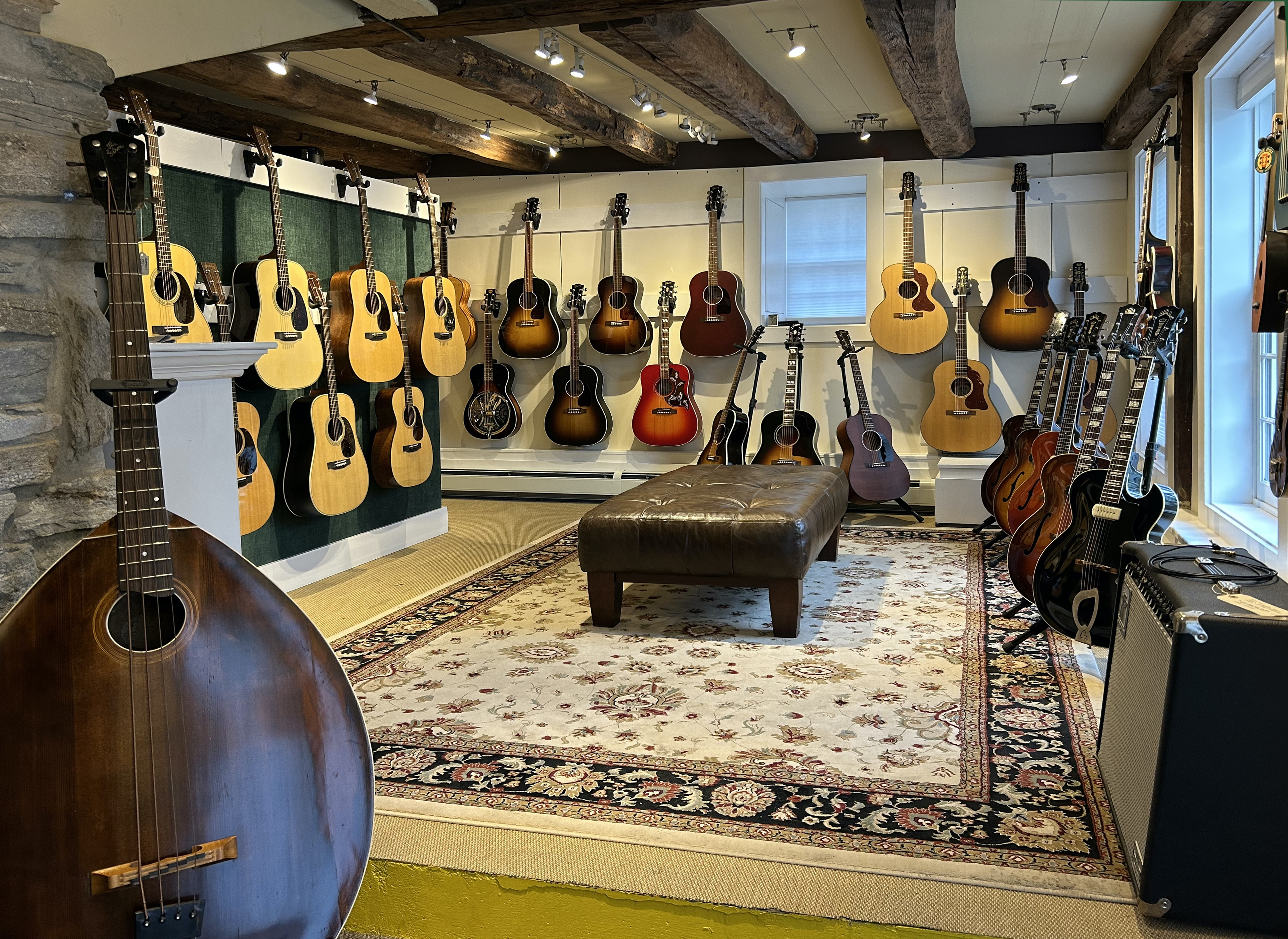 Interior of AcousticMusic.Org guitar shop in Chester, CT showing rare acoustic guitars on display, and mandobass